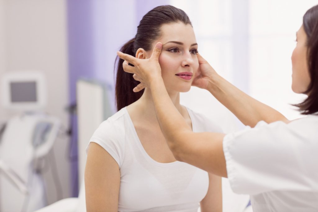 Dermatologist Examining Female Patient